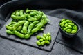 Raw Green edamame soybeans. Black background. Top view