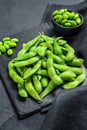 Raw Green edamame soybeans. Black background. Top view