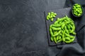 Raw Green edamame soybeans. Black background. Top view. Copy space