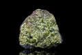 Raw green epidote mineral stone on mother rock in front of black background Royalty Free Stock Photo