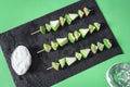 Raw green fruits on sticks with yogurt sauce. Vegetarian skewers Royalty Free Stock Photo