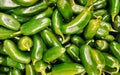 Raw green Jalapeno peppers in a supermarket.