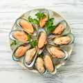 Raw green large mussels with spices on ice. The clams are ready for dinner.