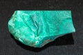 raw green malachite stone on dark background