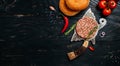 Raw Ground beef lamb meat Burger steak cutlets on dark wooden background with meat cleaver. Long banner format. top view Royalty Free Stock Photo