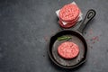 Raw Ground Beef Meat Burger cutlets in cast iron pan. Top view Royalty Free Stock Photo