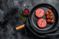 Raw Ground beef meat Burger steak cutlets in a pan. Black background. Top view. Copy space Royalty Free Stock Photo