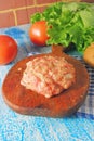 Raw Ground beef meat Burger steak cutlets with seasoning, cheese, tomatoes, salad and bun on vintage wooden boards, black Royalty Free Stock Photo