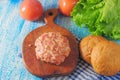 Raw Ground beef meat Burger steak cutlets with seasoning, cheese, tomatoes, salad and bun on vintage wooden boards, black Royalty Free Stock Photo