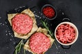 Raw Ground beef meat Burger steak cutlets  and seasonings. Farm organic meat. Black background. Top view Royalty Free Stock Photo