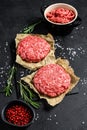 Raw Ground beef meat Burger steak cutlets and seasonings. Farm organic meat. Black background. Top view Royalty Free Stock Photo