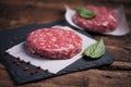 Raw ground beef meat burger steak cutlets on wooden background Royalty Free Stock Photo