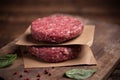 Raw ground beef meat burger steak cutlets on wooden background Royalty Free Stock Photo
