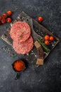 Raw Ground beef meat Burger steak cutlets on a wooden board, Food recipe background. Close up Royalty Free Stock Photo