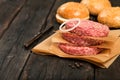 Raw ground beef meat burger steak cutlets on wooden table Royalty Free Stock Photo