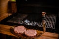 Raw ground beef meat hamburger patties on paper, dry pepper.raw beef or pork meat barbecue burgers.Healthy food, cooking Royalty Free Stock Photo