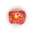 Raw ground beef, minced beef with egg and salt in a bowl isolated over white background. Flat lay Royalty Free Stock Photo