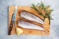 Raw hake fish carcass on a wooden chopping Board. top view Copy space Royalty Free Stock Photo