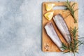 Raw hake fish carcass on a wooden chopping Board. top view Copy space Royalty Free Stock Photo