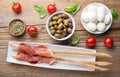 Raw ham and breadsticks with cherry tomatoes, taggiasca olives and small mozzarella. Top view Royalty Free Stock Photo
