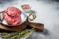 Raw Hamburger patty, groud beef Meat, uncooked meat cutlets. White background. Top view. Space for text