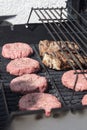 Raw hamburgers being cooked on the grill Royalty Free Stock Photo