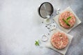Raw hamburgers - cutlets from organic beef meat with spices and basil on a stone or slate background Royalty Free Stock Photo