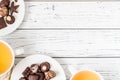 Raw handmade chocolate candies, two cups of tea on white wooden table Royalty Free Stock Photo