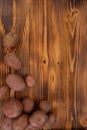 Raw harvested red potatoes on wooden textured background. Fresh vegetables, top view and copy space Royalty Free Stock Photo