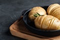 Raw Hasselback potatoes with rosemary in baking pan on dark grey table, closeup. Space for text Royalty Free Stock Photo