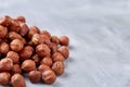 Raw hazelnut on heap isolated on white background, selective focus, shallow depth of field