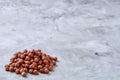 Raw hazelnut on heap on white background, selective focus, shallow depth of field
