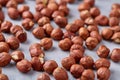 Raw hazelnut on heap on white background, selective focus, shallow depth of field