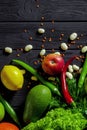 Raw healthy food, grocery set on a black wooden table