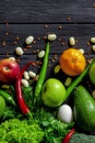 Raw healthy food, grocery set on a black wooden table