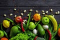 Raw healthy food, grocery set on a black wooden table