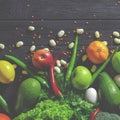 Raw healthy food, grocery set on a black wooden table