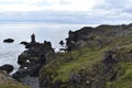 Hiking trail from Anarstapi to Hellnar with the raw ocean und big rocks and mountains in the west of Iceland at Snaefellsnes Penin