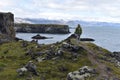 Hiking trail from Anarstapi to Hellnar with the raw ocean und big rocks and mountains in the west of Iceland at Snaefellsnes Penin