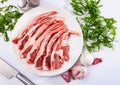 Raw hogget chops on plate with arugula, garlic and seasonings Royalty Free Stock Photo