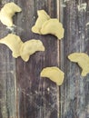 Raw homemade dumplings with potatoes on a wooden board close-up. Dough product Royalty Free Stock Photo