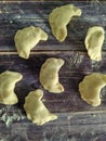 Raw homemade dumplings with potatoes on a wooden table close-up. Dough product. View from above Royalty Free Stock Photo