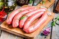 Raw homemade sausages on cutting board with rosemary Royalty Free Stock Photo