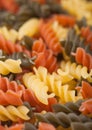 Raw homemade tricolore fusilli pasta as texture background