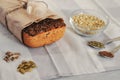 Raw homemade vegan sourdough bread made of green buckwheat with flax seeds, sunflower, pumpkin in a paper Kraft bag. Healthy and Royalty Free Stock Photo