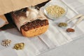 Raw homemade vegan sourdough bread made of green buckwheat with flax seeds, sunflower, pumpkin in a paper Kraft bag. Healthy and Royalty Free Stock Photo