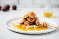 raw honey drizzle over figs on marble slab Royalty Free Stock Photo