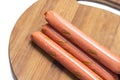 Raw hot dogs on the cutting wooden board