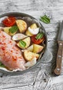 Raw ingredients - chicken breast, potatoes, onions, tomatoes. For cooking chicken breast with vegetables. Royalty Free Stock Photo
