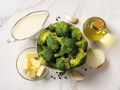 Raw ingredients for cooking cream of broccoli soup: broccoli florets, cream, butter, garlic, onion and olive oil. Puree soup of Royalty Free Stock Photo